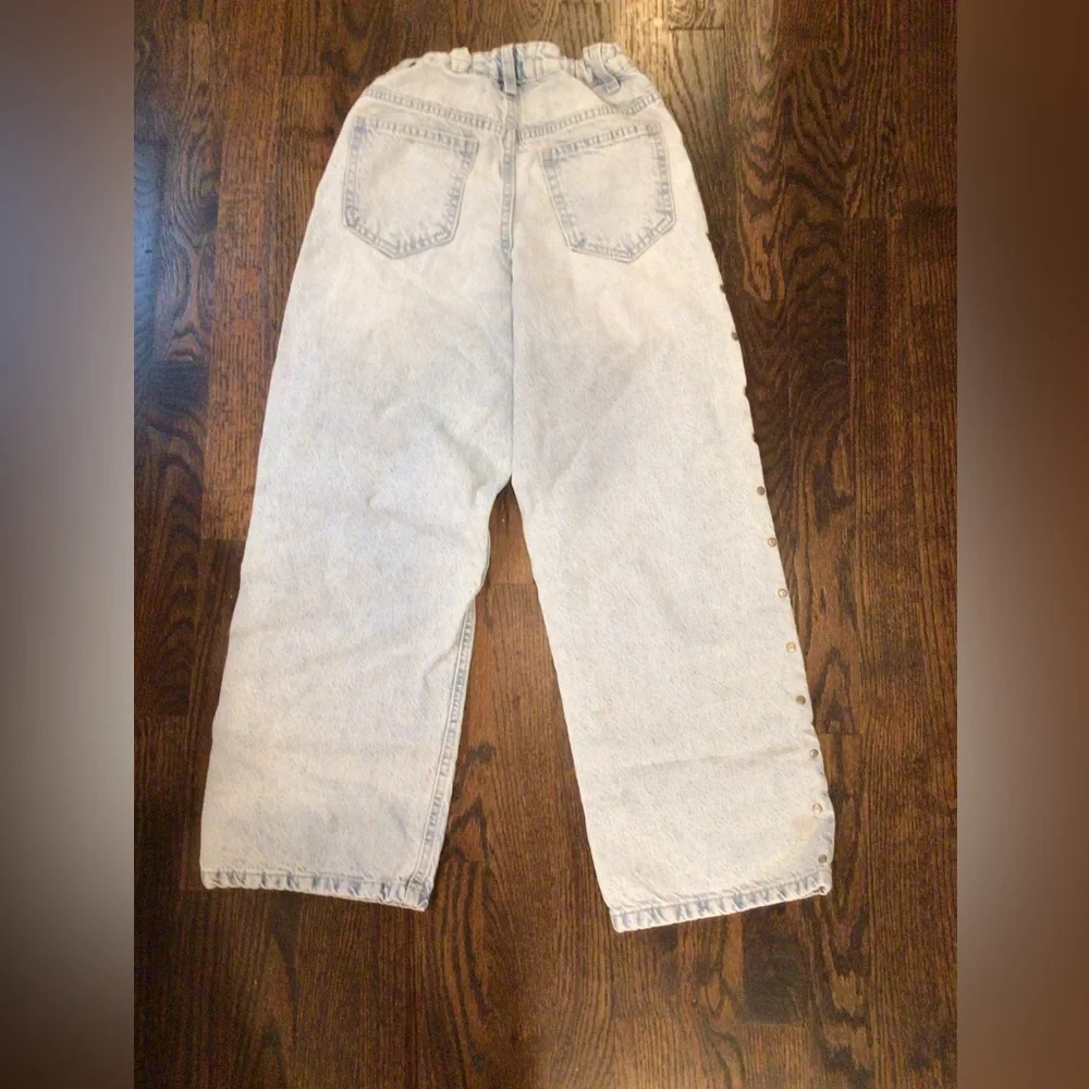Primark - light-wash wide-leg jeans featuring side metal stud details.